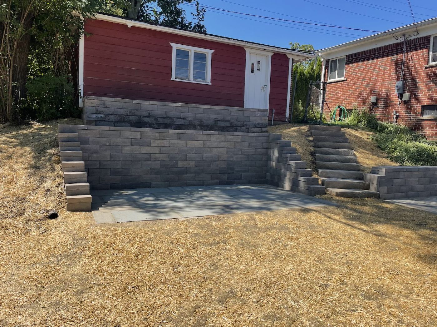 Finished terraced walls and patio in front of the garage after the rebuild