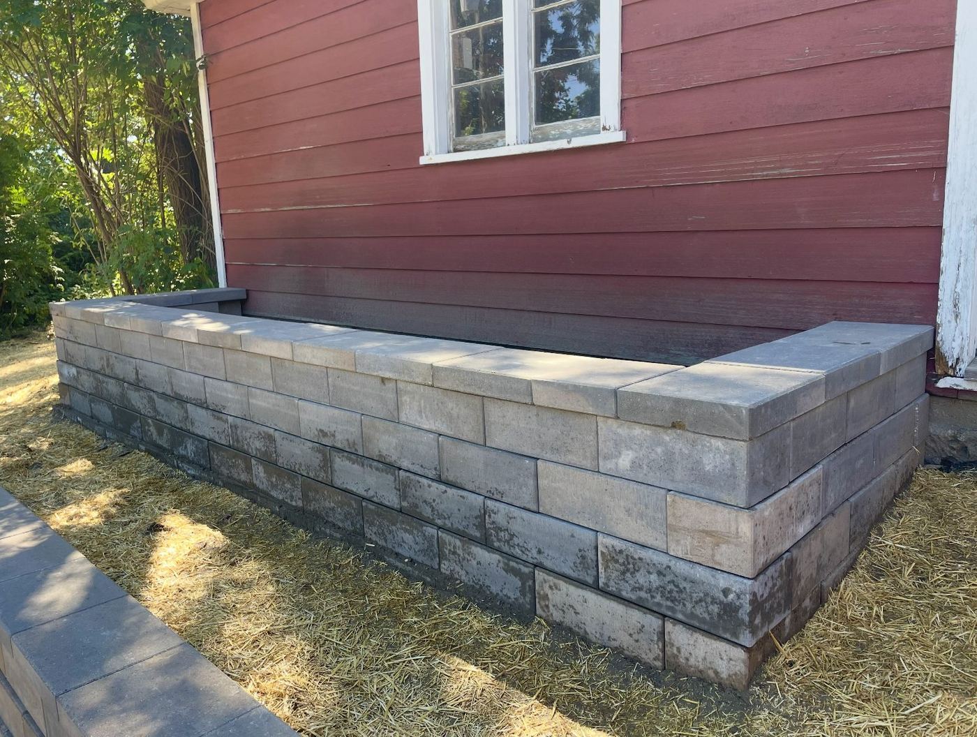 Block planter and seating wall built along a garage