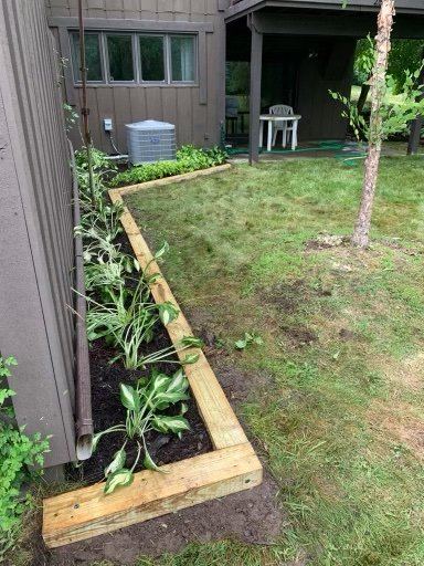 Cedar raised bed along home foundation with new plantings