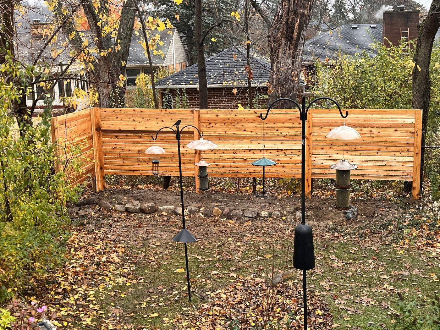 Finished cedar privacy screen fence in a mature yard