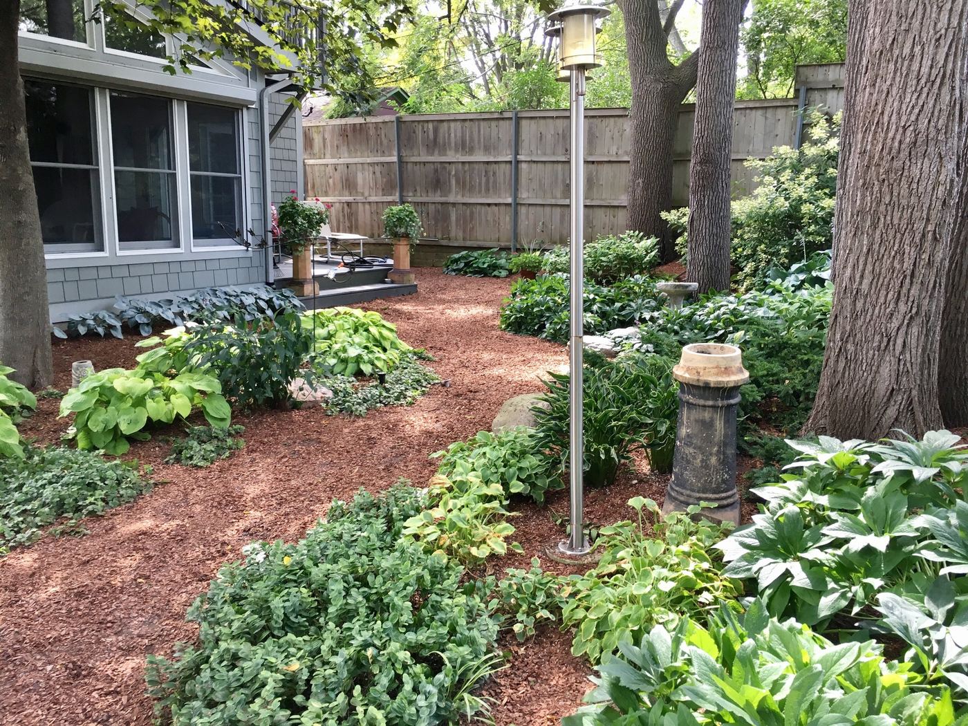 Shaded hosta garden path along the home's foundation