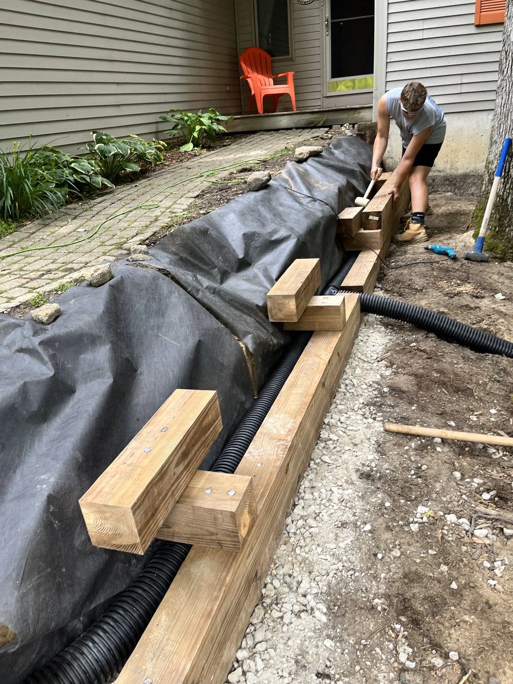 Wood retaining wall footing before backfill and finishing